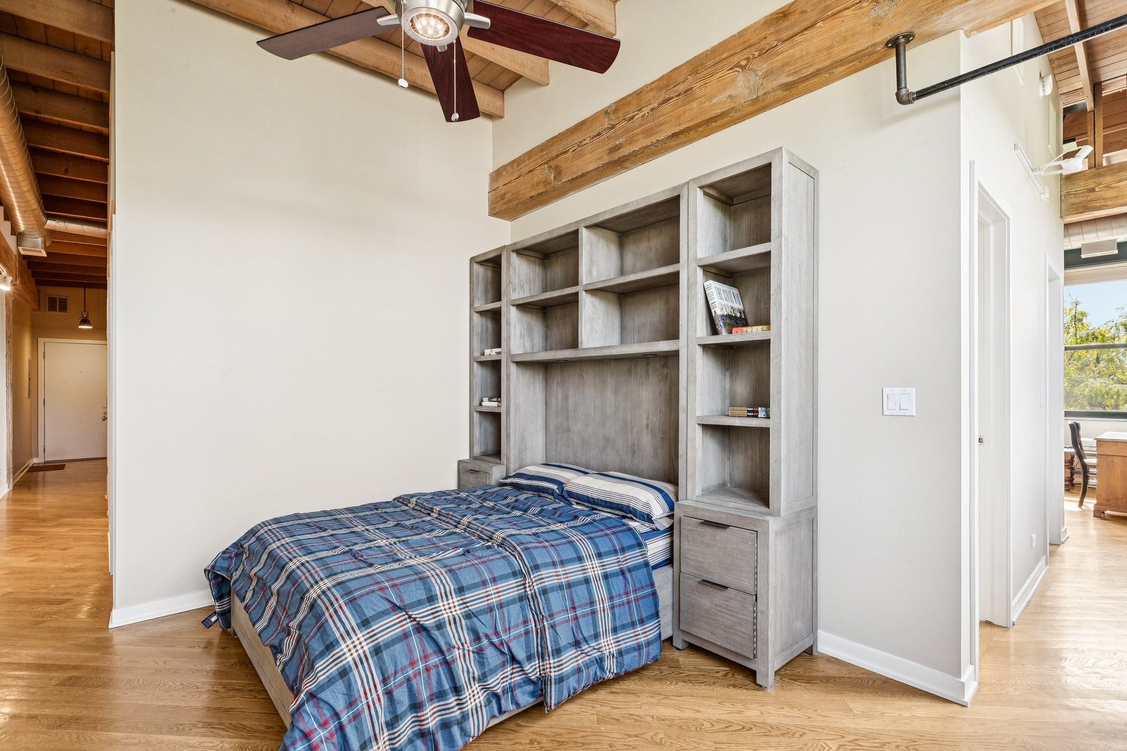 3201 North Ravenswood Avenue, Unit 301 Chicago, IL 60657 - Photo 27 of 38 a bedroom with a bed closet and wooden floor