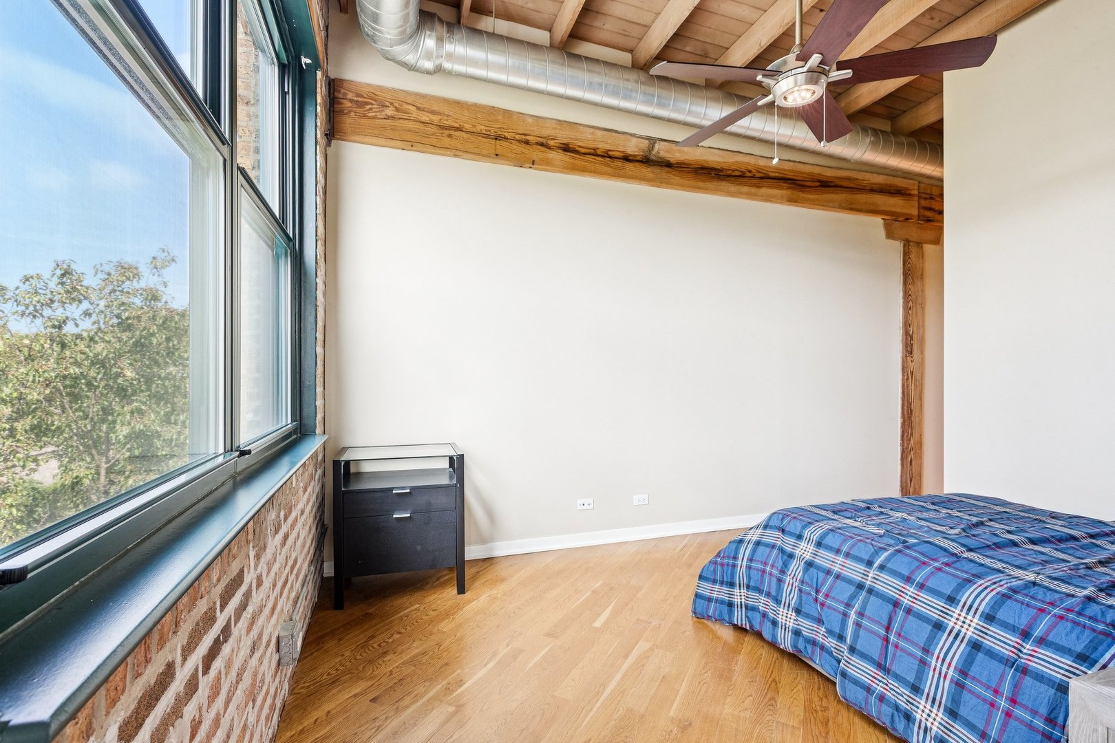 3201 North Ravenswood Avenue, Unit 301 Chicago, IL 60657 - Photo 28 of 38 a bedroom with a bed and a window