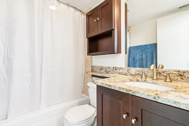 a kitchen with granite countertop a sink and a stove