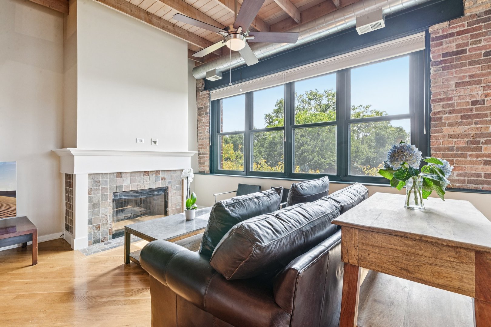 3201 North Ravenswood Avenue, Unit 301 Chicago, IL 60657 - Photo 4 of 38 a living room with furniture and a fireplace