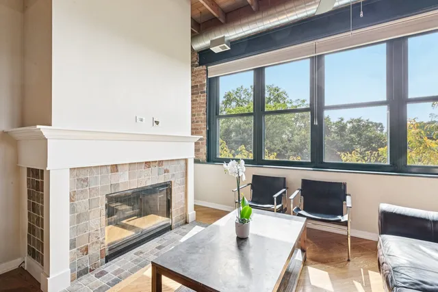 a view of a dining room with furniture and a fireplace
