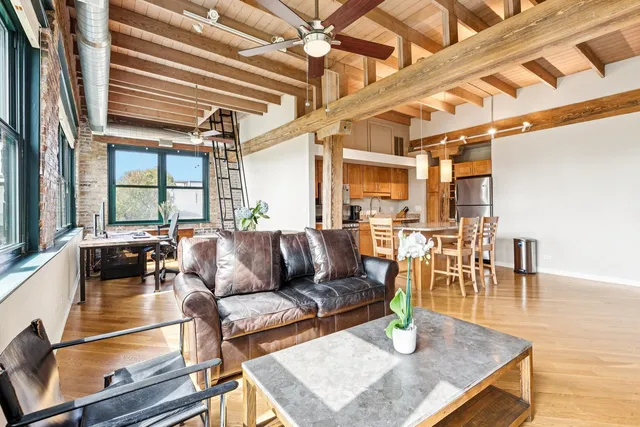 a living room with furniture a wooden floor and appliances