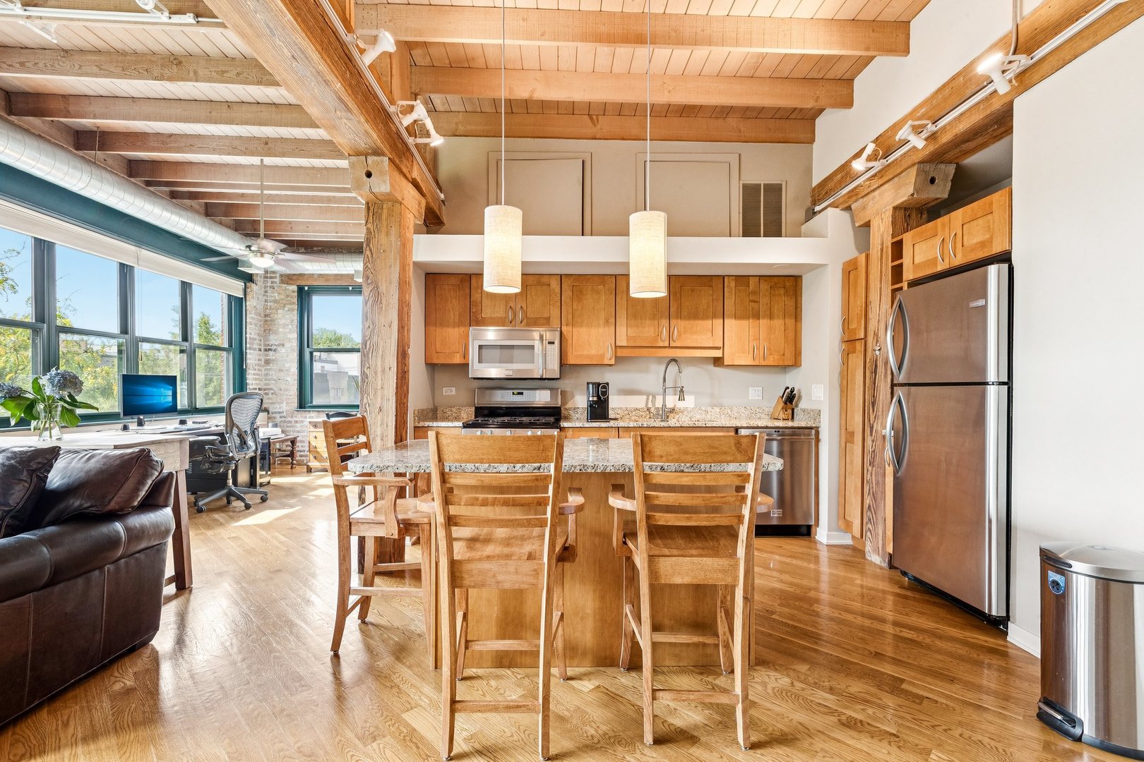3201 North Ravenswood Avenue, Unit 301 Chicago, IL 60657 - Photo 9 of 38 a dining hall with stainless steel appliances kitchen island granite countertop a dining table chairs and view of living room
