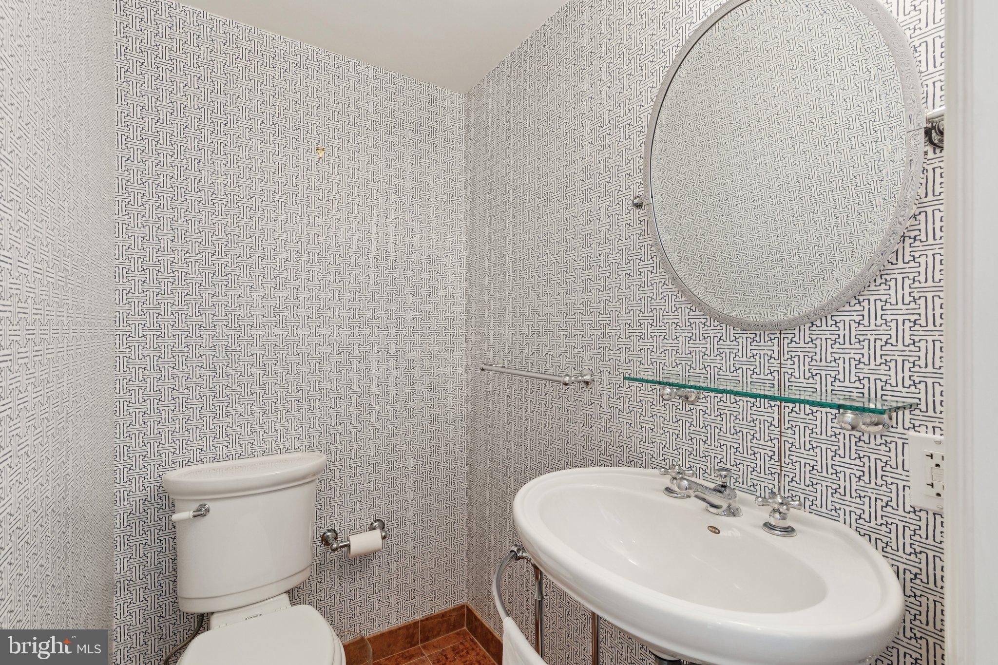 237-47 South 18th Street, Unit 4D Philadelphia, PA 19103 - Photo 14 of 19 a bathroom with a sink a toilet and a mirror