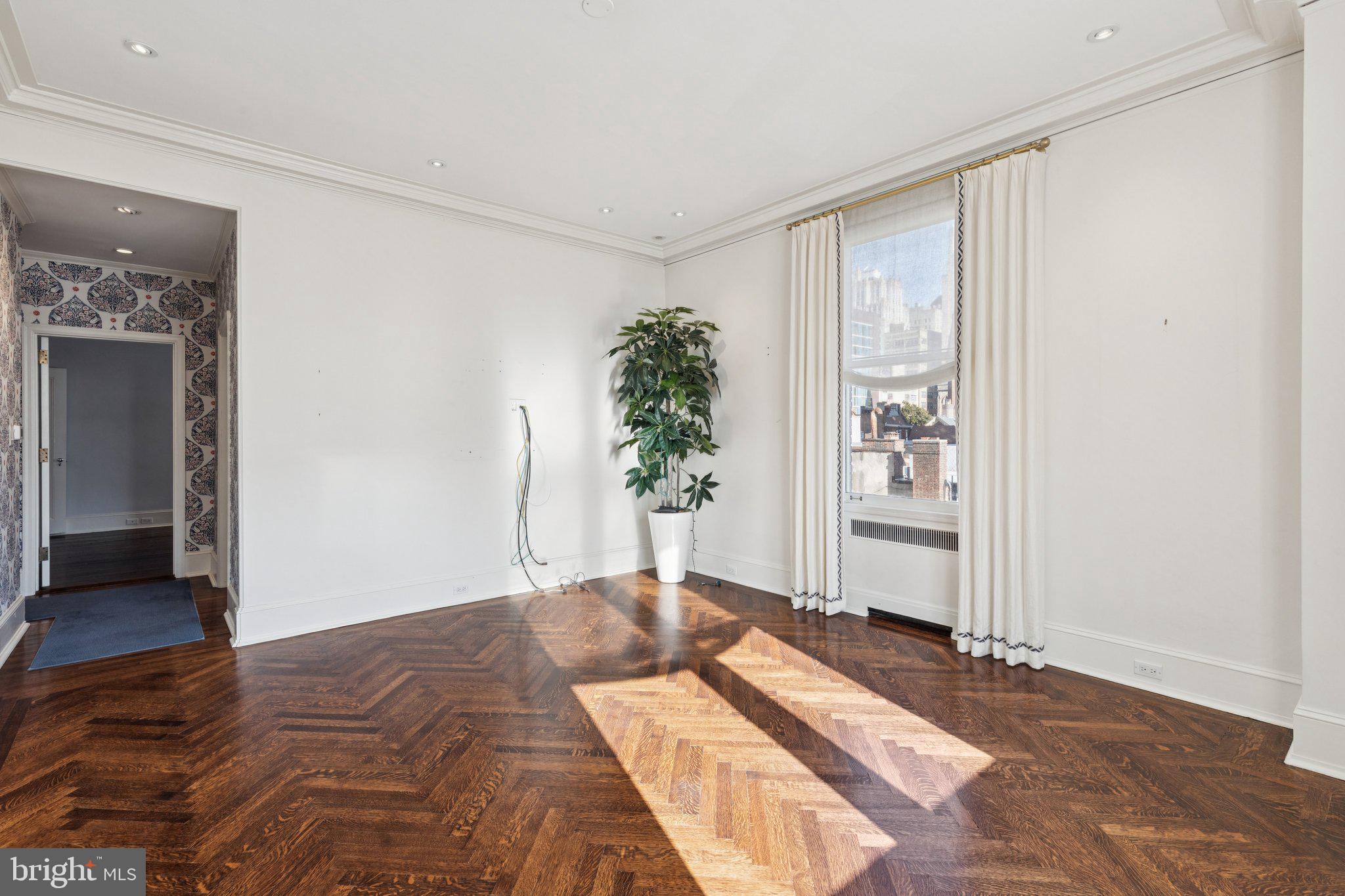 237-47 South 18th Street, Unit 4D Philadelphia, PA 19103 - Photo 3 of 19 a bedroom with a bed and a potted plant
