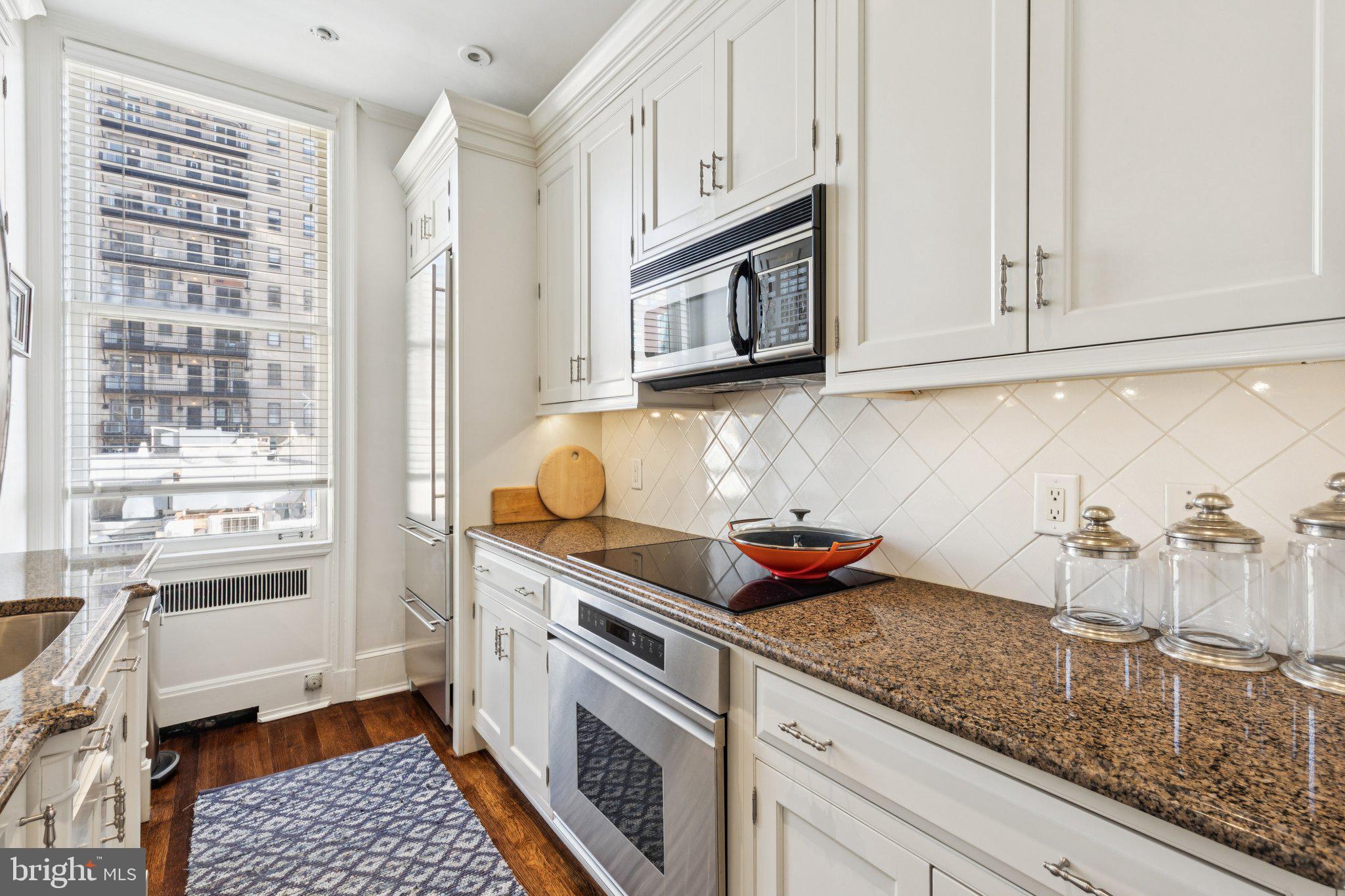 237-47 South 18th Street, Unit 4D Philadelphia, PA 19103 - Photo 5 of 19 a kitchen with stainless steel appliances granite countertop a sink and cabinets