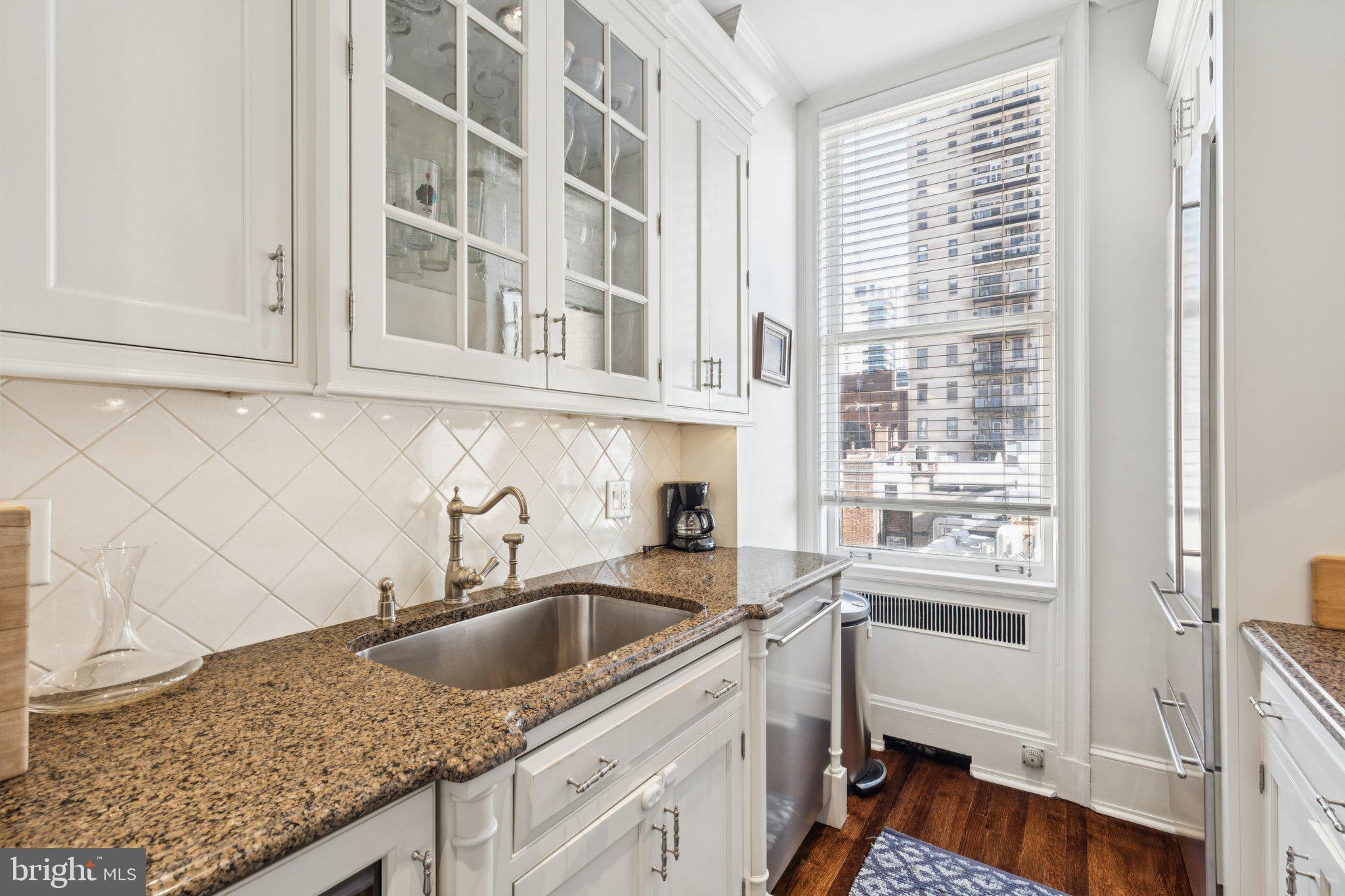 237-47 South 18th Street, Unit 4D Philadelphia, PA 19103 - Photo 6 of 19 a kitchen with granite countertop a sink and a stove
