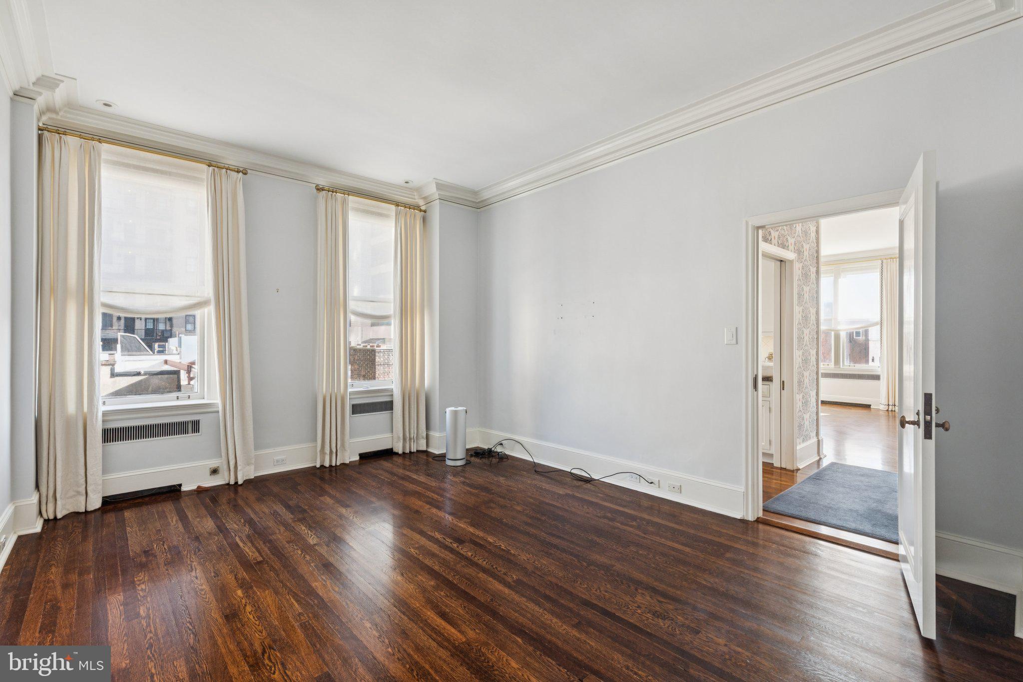 237-47 South 18th Street, Unit 4D Philadelphia, PA 19103 - Photo 8 of 19 an empty room with wooden floor and windows