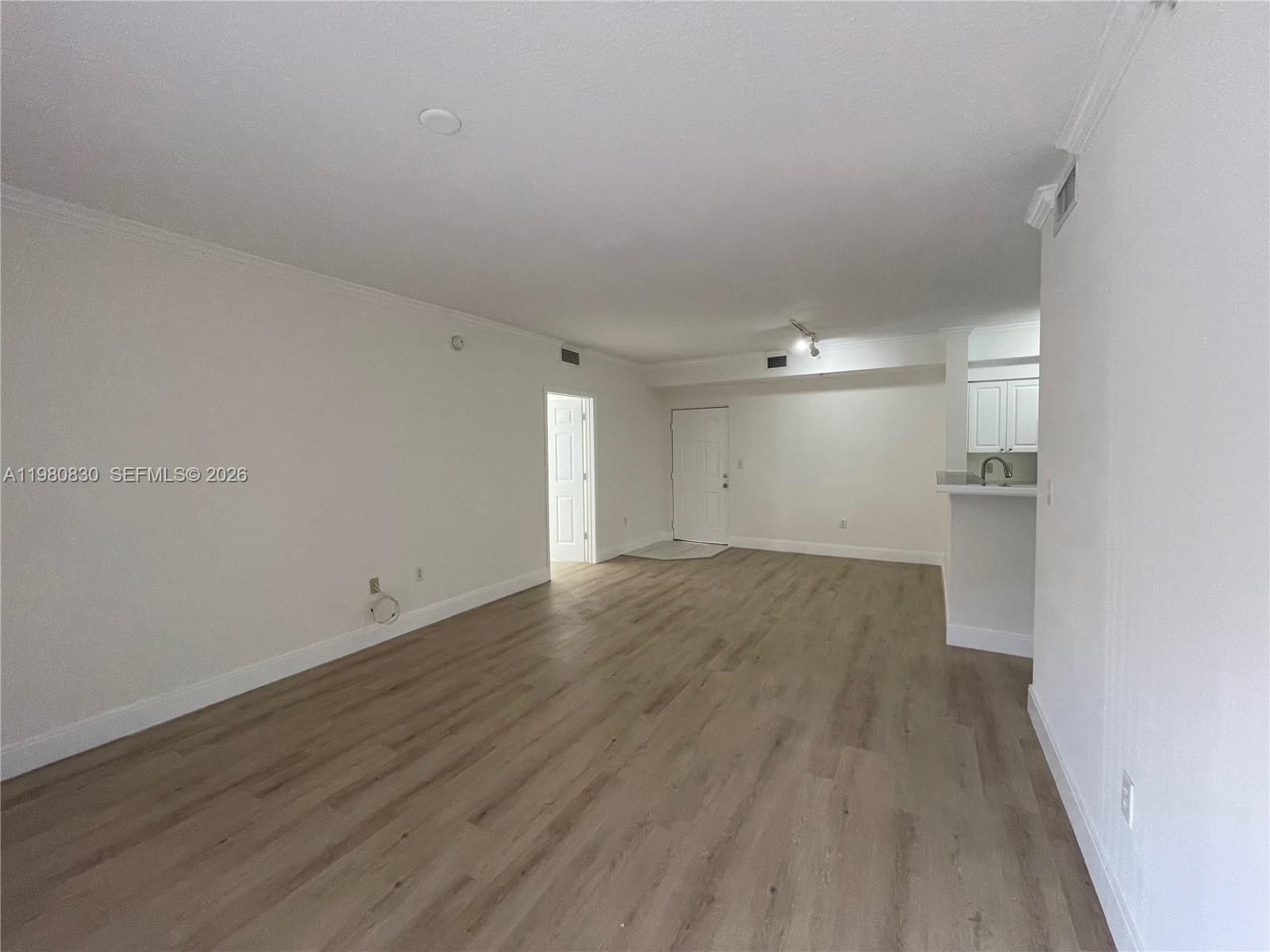 6821 Southwest 44th Street, Unit 301 Miami, FL 33155 - Photo 11 of 12 wooden floor in an empty room