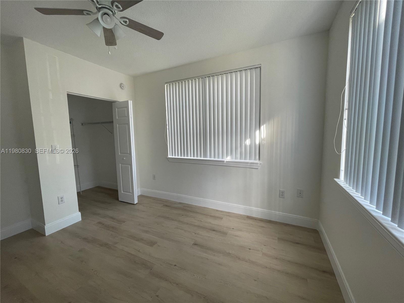 6821 Southwest 44th Street, Unit 301 Miami, FL 33155 - Photo 3 of 12 an empty room with fan and windows