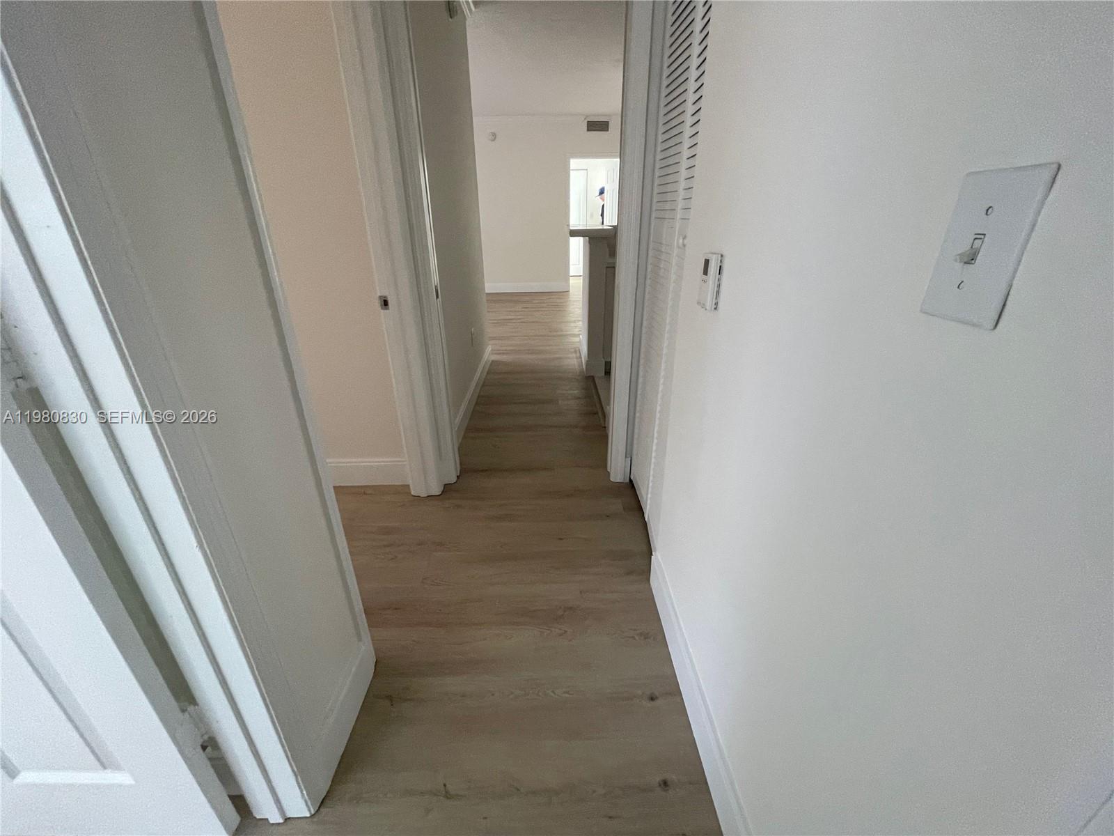 6821 Southwest 44th Street, Unit 301 Miami, FL 33155 - Photo 4 of 12 a view of a hallway with wooden floor and staircase