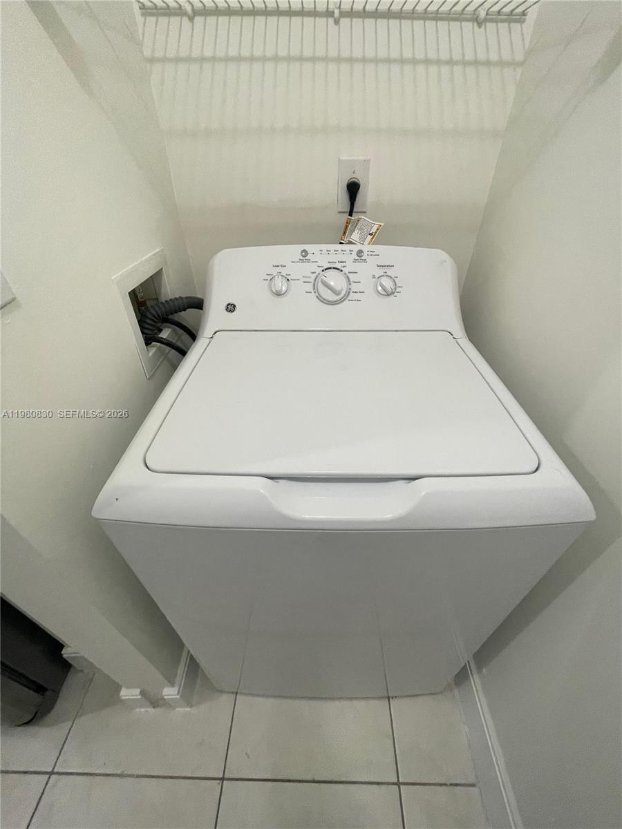 6821 Southwest 44th Street, Unit 301 Miami, FL 33155 - Photo 9 of 12 a close up view of washer and dryer