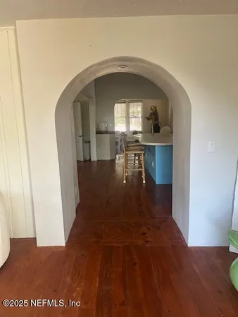 a view of entryway and hall with wooden floor