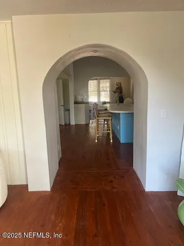 a view of entryway and hall with wooden floor