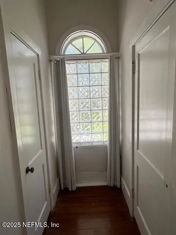 a view of front door with wooden floor