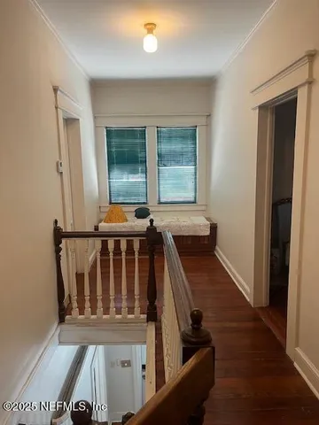 a view of an entryway with wooden floor