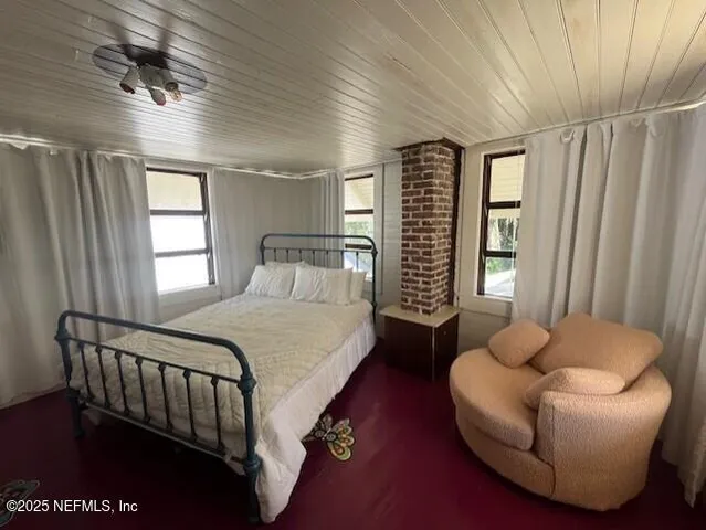 a bedroom with a bed couch and window