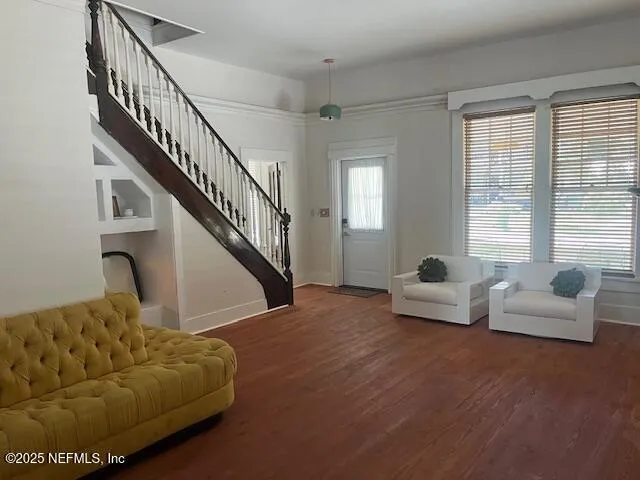 a living room with furniture and stairs