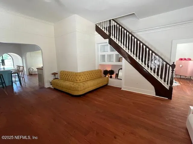 a living room with furniture and stairs