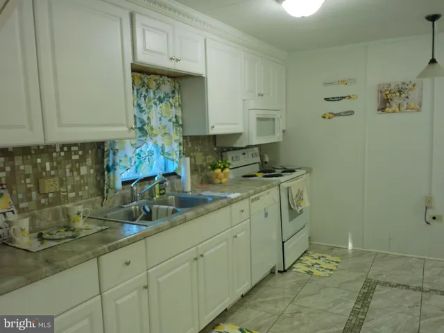 a kitchen with sink and cabinets