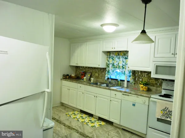 a kitchen with sink and cabinets
