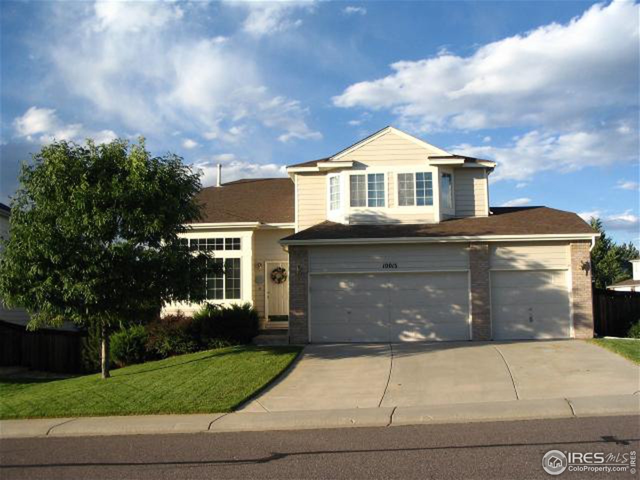 10015 Silver Maple Road Littleton, CO 80129 - Photo 1 of 11 a front view of a house with a yard and garage