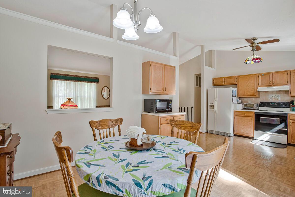 70 South View Drive Huntingtown, MD 20639 - Photo 13 of 34 a view of a dining room with furniture a chandelier and wooden floor