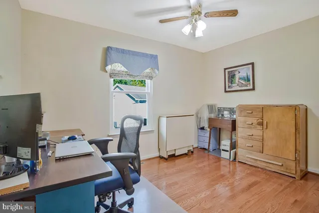 a view of workspace with wooden floor windows