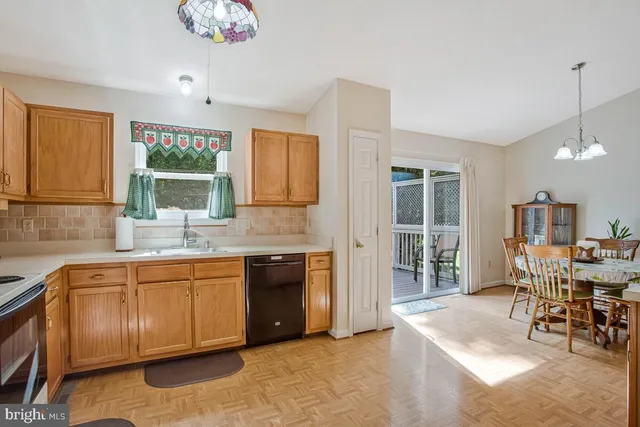 a kitchen with a sink cabinets and window