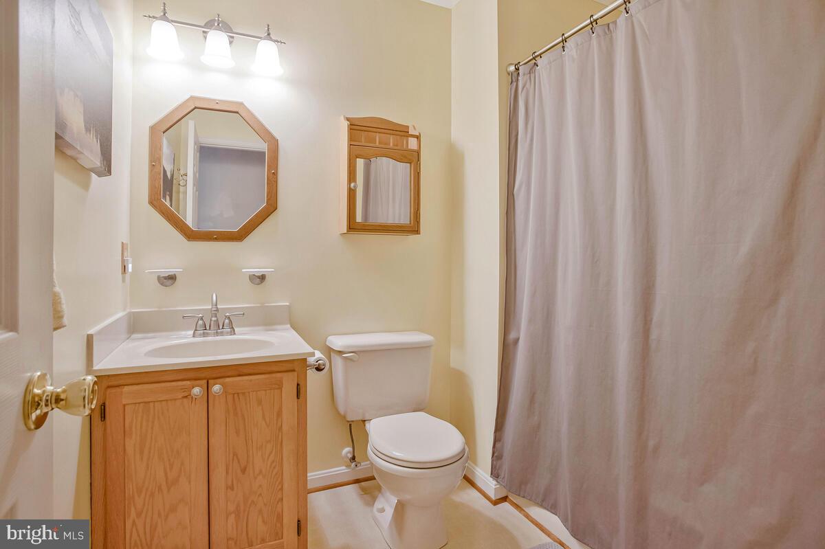 70 South View Drive Huntingtown, MD 20639 - Photo 22 of 34 a bathroom with a toilet sink vanity and mirror