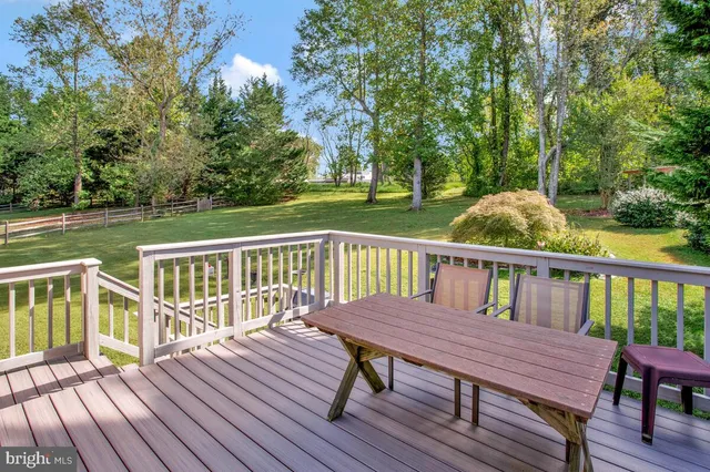 a view of a deck with two chairs and wooden floor