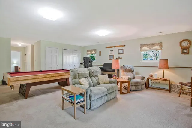 a living room with furniture a lamp and a window