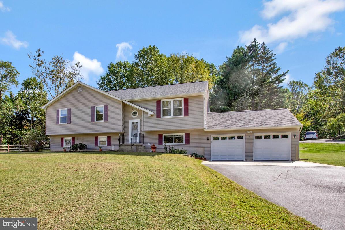 70 South View Drive Huntingtown, MD 20639 - Photo 7 of 34 a front view of a house with a yard and garage