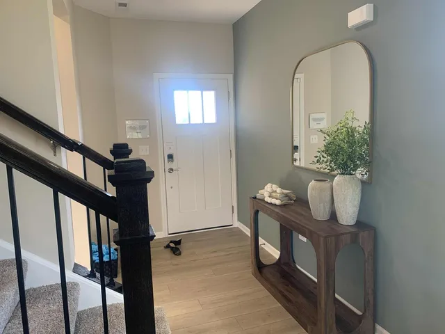 a view of an entryway with wooden floor