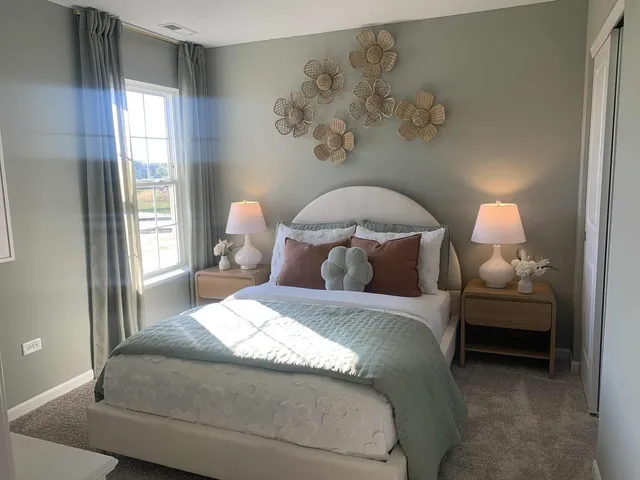 a bedroom with a bed and a painting on the wall