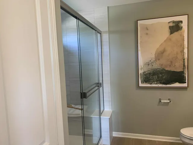 a bathroom with a glass shower door