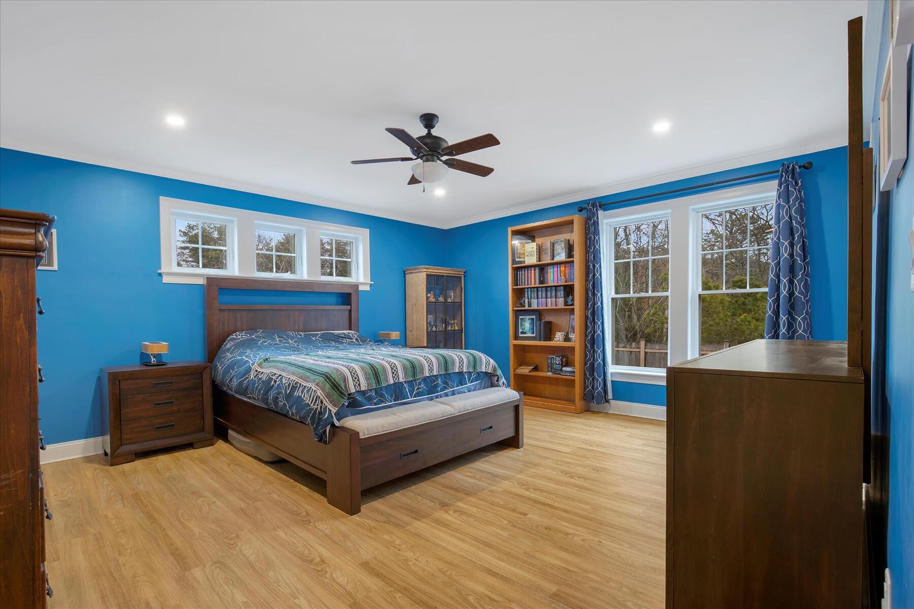 7 Maxwell Lane Sandwich, MA 02563 - Photo 20 of 54 a spacious bedroom with a large bed and a chandelier