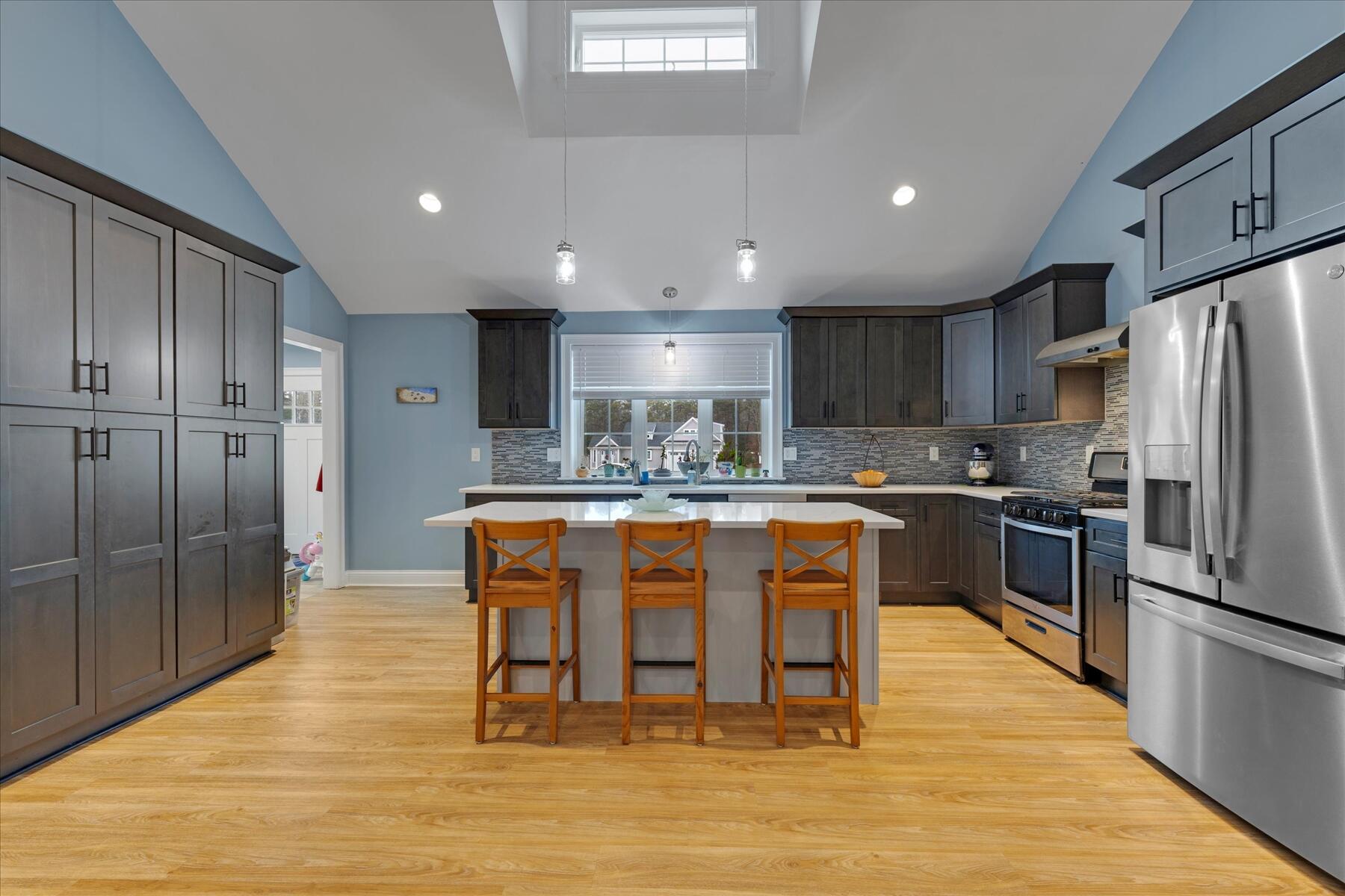 7 Maxwell Lane Sandwich, MA 02563 - Photo 8 of 54 a kitchen with stainless steel appliances granite countertop a refrigerator a stove top oven and cabinets