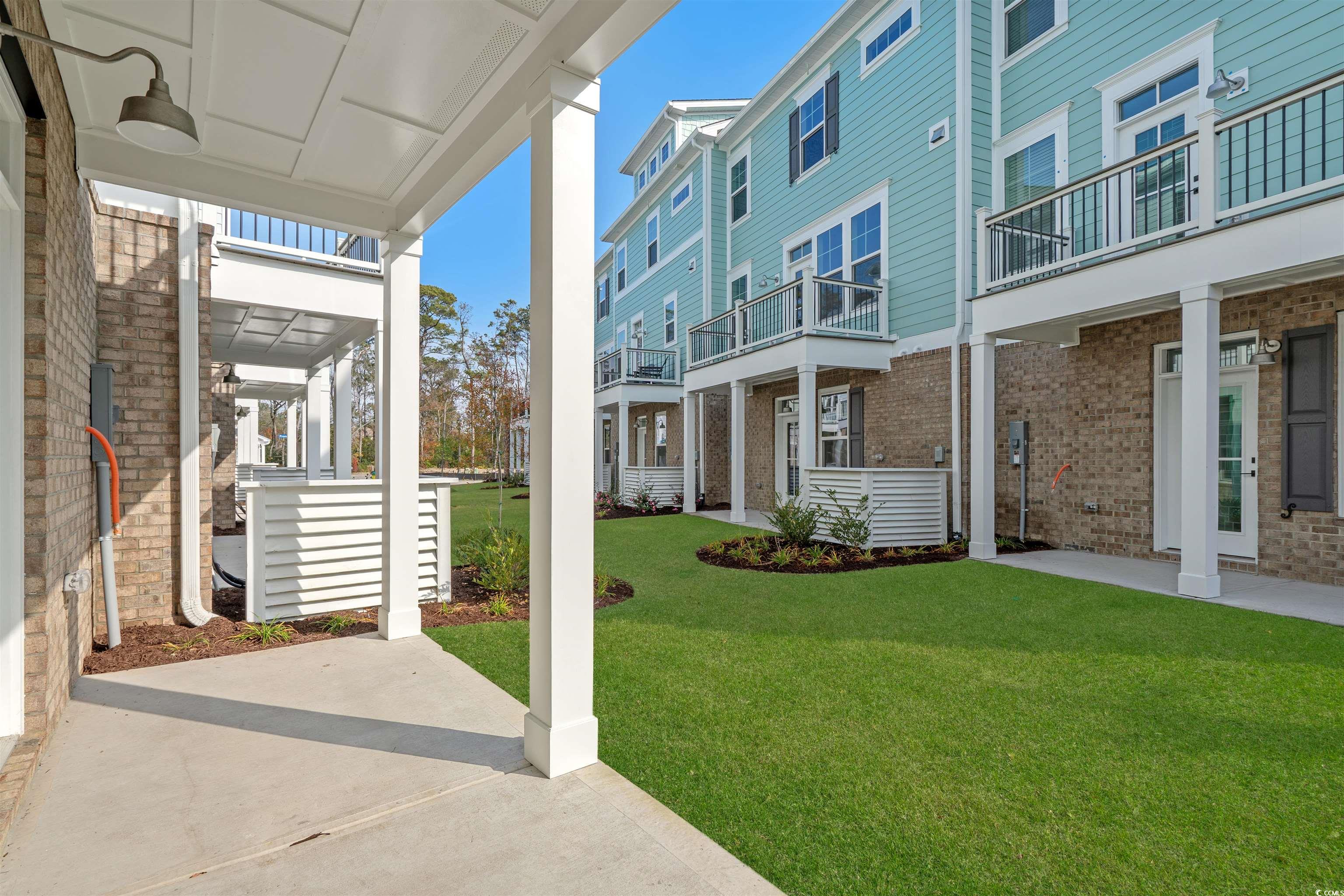 8476 Duke Place, Unit 32 Myrtle Beach, SC 29572 - Photo 21 of 40 View of grassy yard with a balcony
