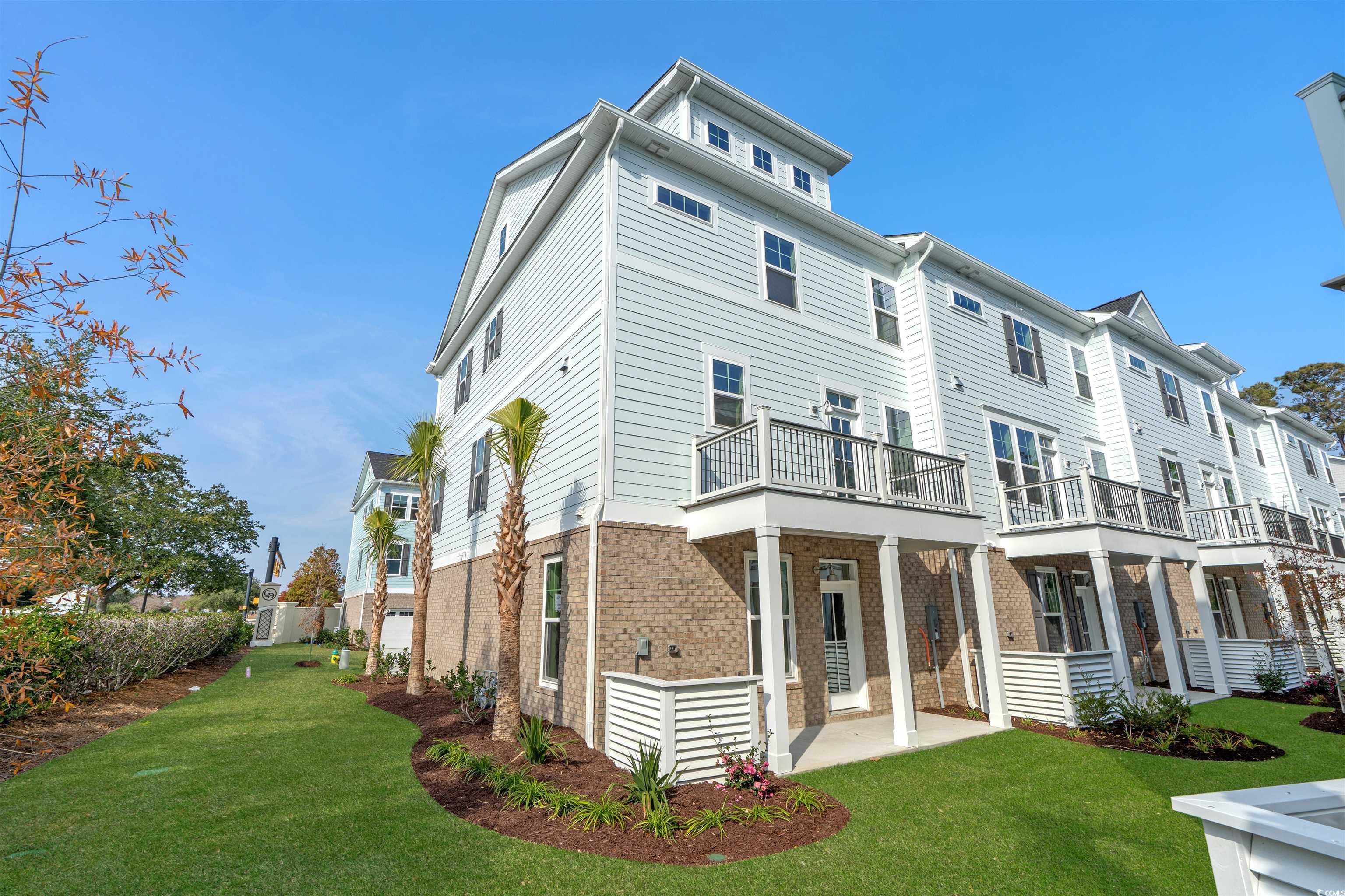 8476 Duke Place, Unit 32 Myrtle Beach, SC 29572 - Photo 22 of 40 View of front of house featuring brick siding and a front lawn