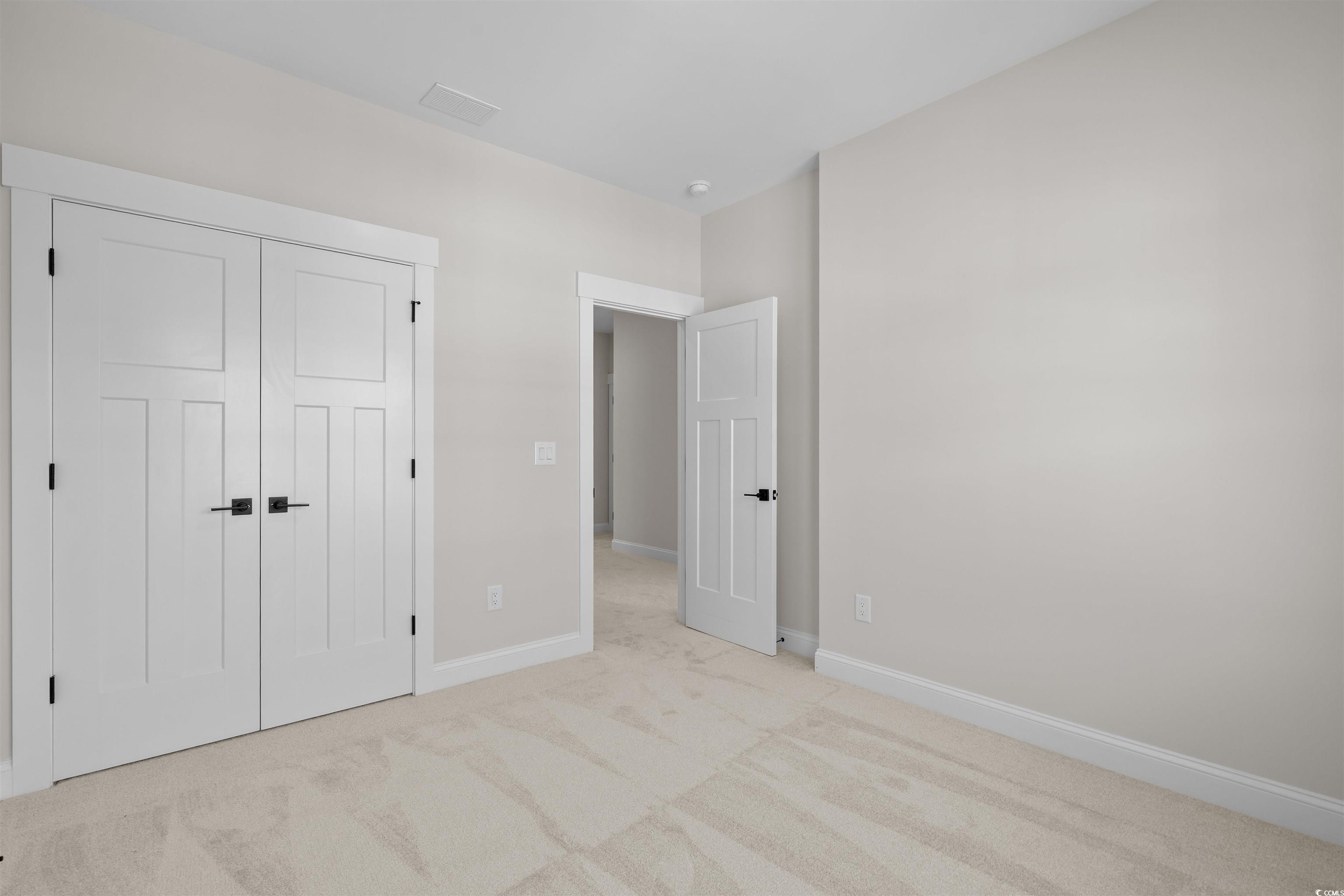 8476 Duke Place, Unit 32 Myrtle Beach, SC 29572 - Photo 33 of 40 Unfurnished bedroom with carpet floors and a closet