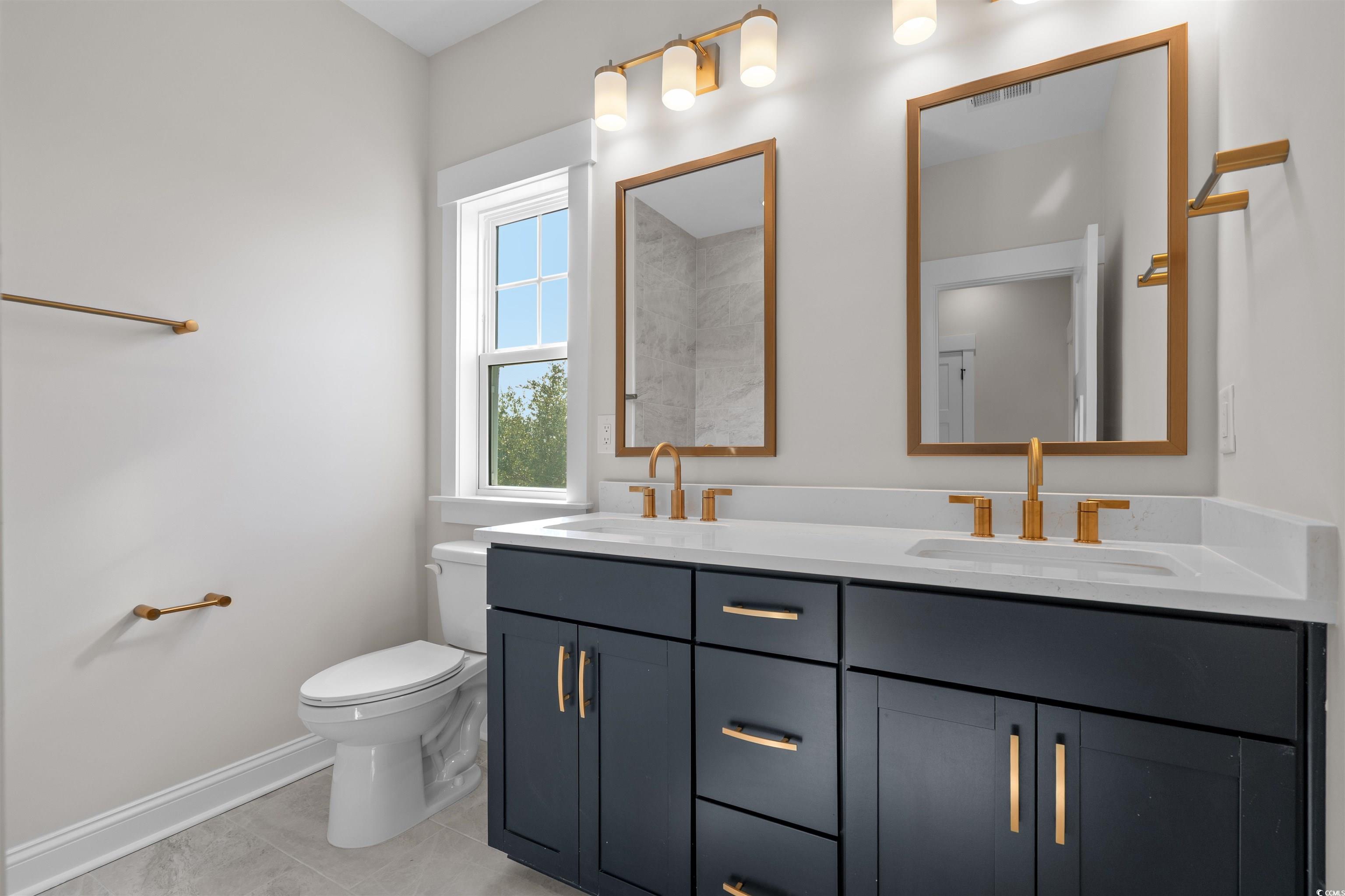 8476 Duke Place, Unit 32 Myrtle Beach, SC 29572 - Photo 34 of 40 Bathroom with double vanity and light tile patterned floors