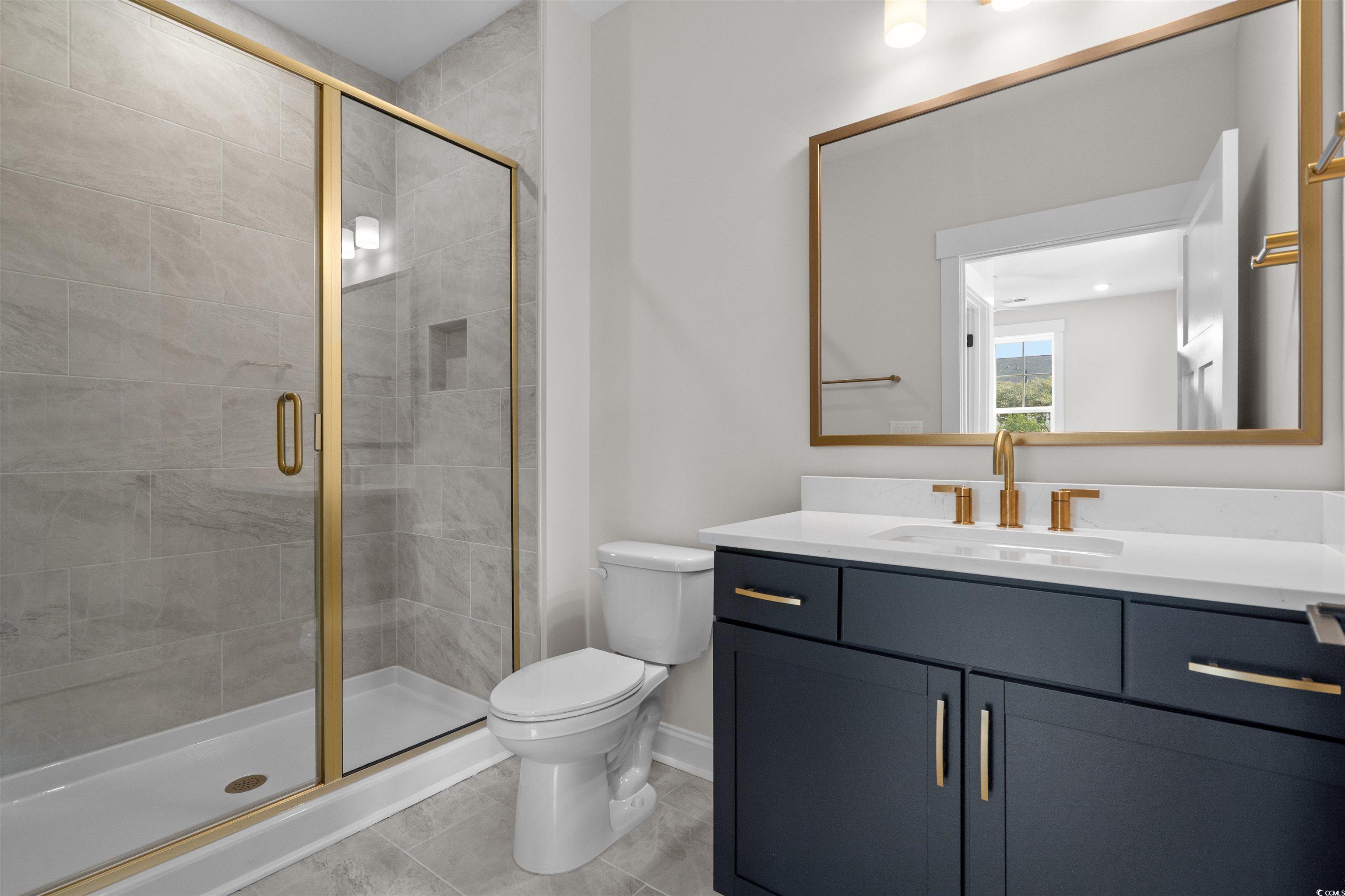 8476 Duke Place, Unit 32 Myrtle Beach, SC 29572 - Photo 39 of 40 Bathroom featuring vanity, a shower stall, and light tile patterned floors