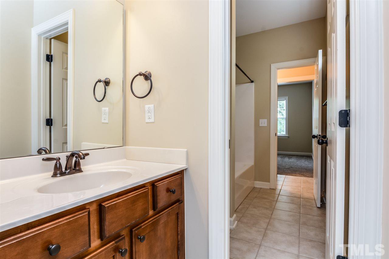 2261 Dunlin Lane Raleigh, NC 27614 - Photo 20 of 25 a bathroom with a sink and a mirror