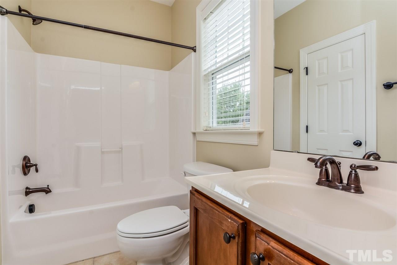 2261 Dunlin Lane Raleigh, NC 27614 - Photo 21 of 25 a bathroom with a sink a toilet and a bathtub