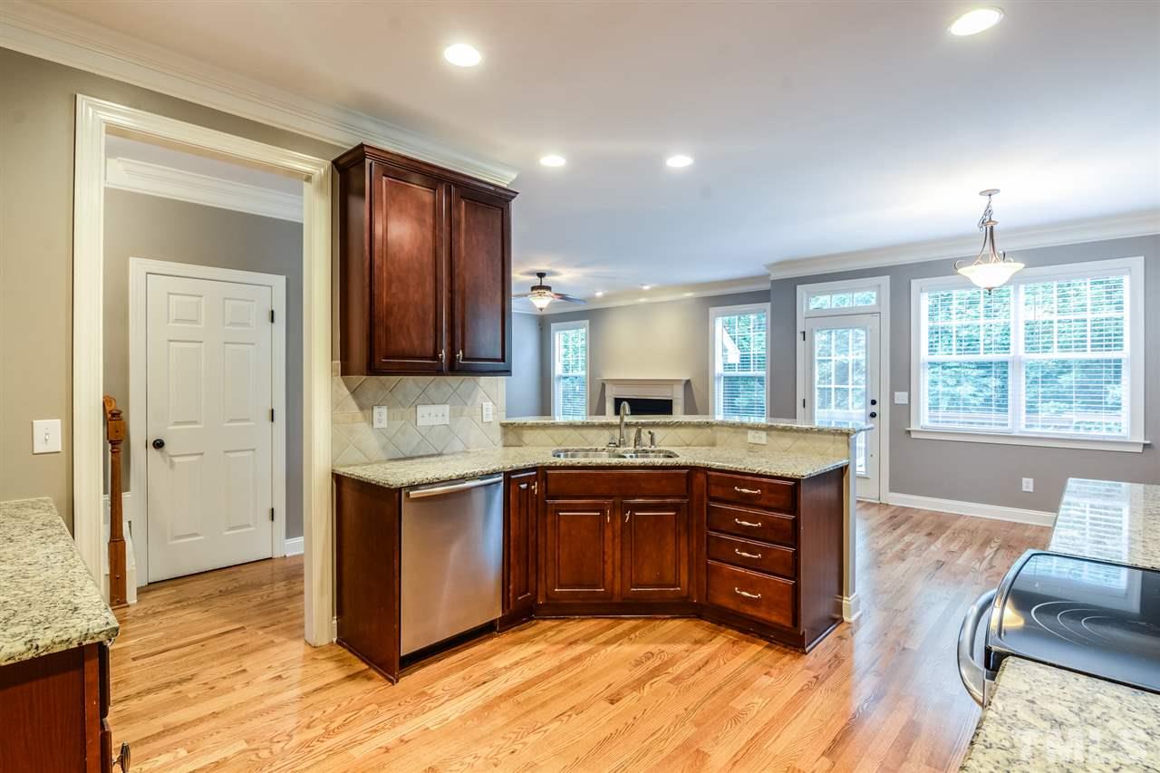 2261 Dunlin Lane Raleigh, NC 27614 - Photo 6 of 25 a large kitchen with stainless steel appliances granite countertop a sink and wooden floors