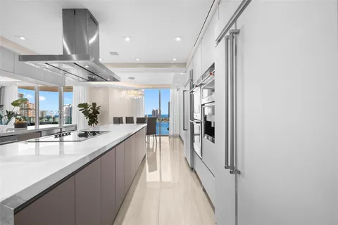 a large white kitchen with a large window