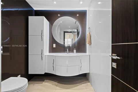 a kitchen with stainless steel appliances kitchen island granite countertop a refrigerator and a sink