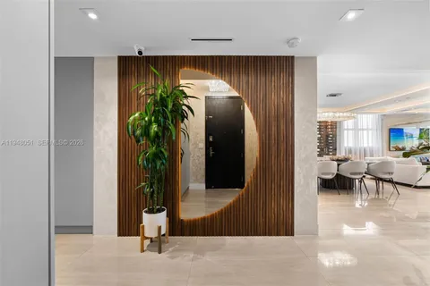 a spacious bedroom with a bed and a chandelier