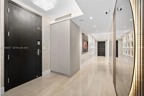 an outdoor living room with furniture and a floor to ceiling window